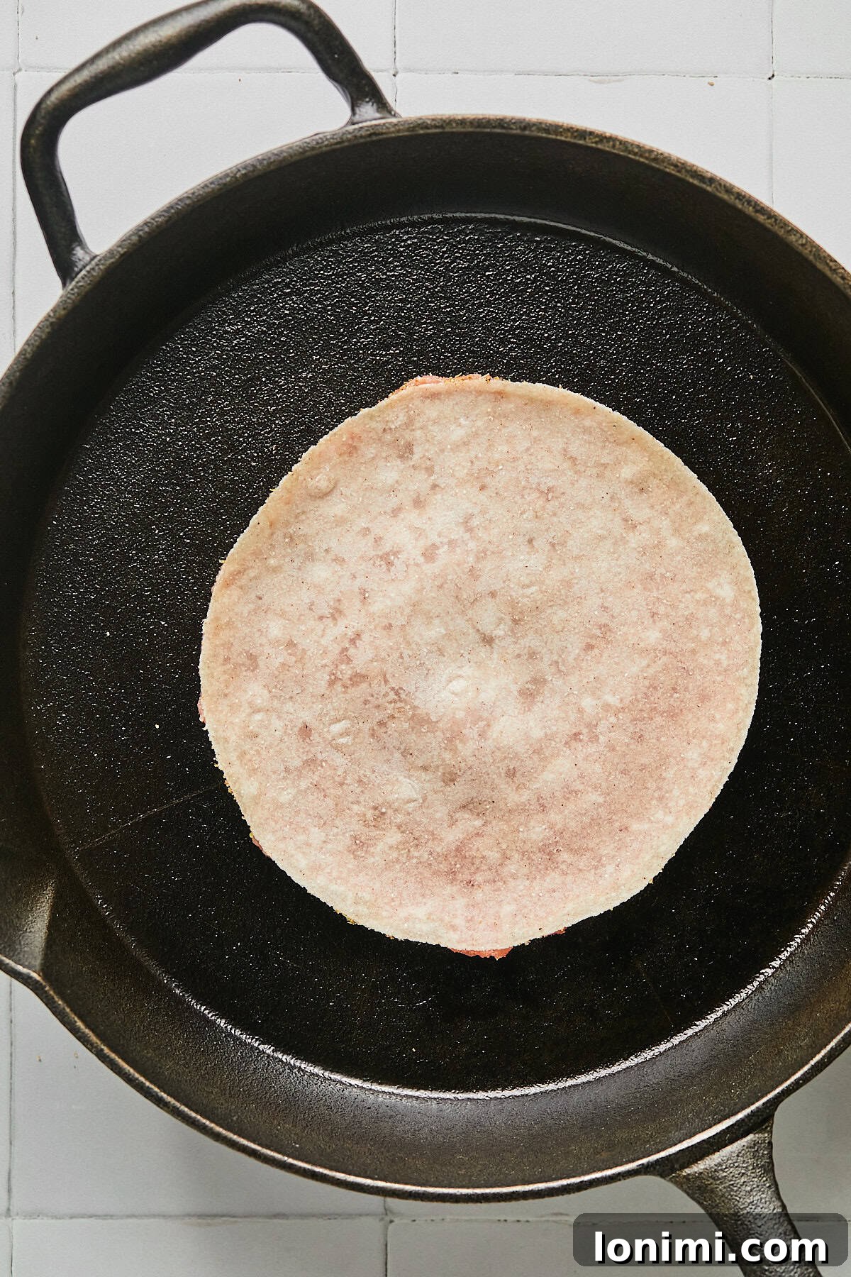 a tortilla in a cast iron pan