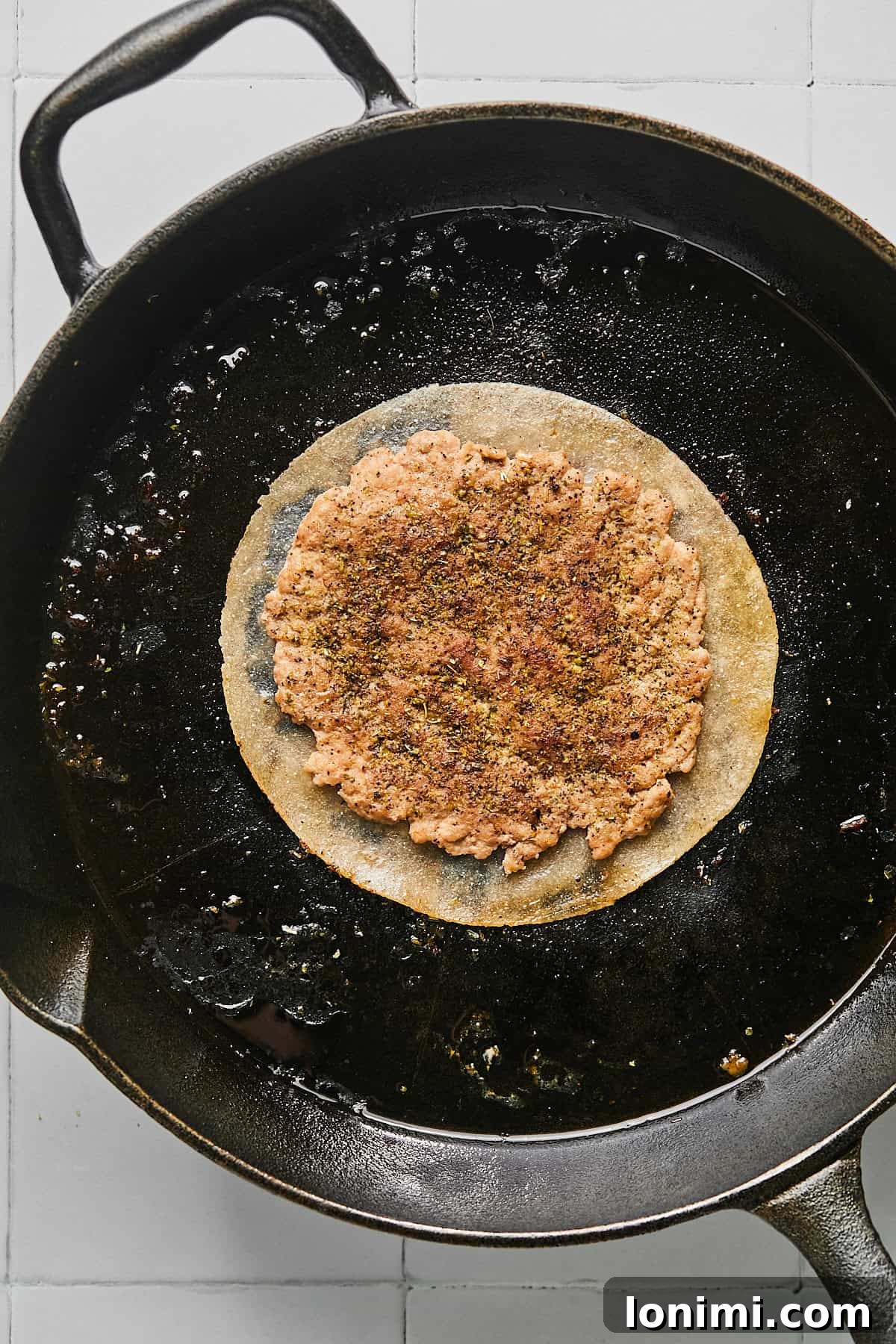 turkey smash burger in a cast iron pan