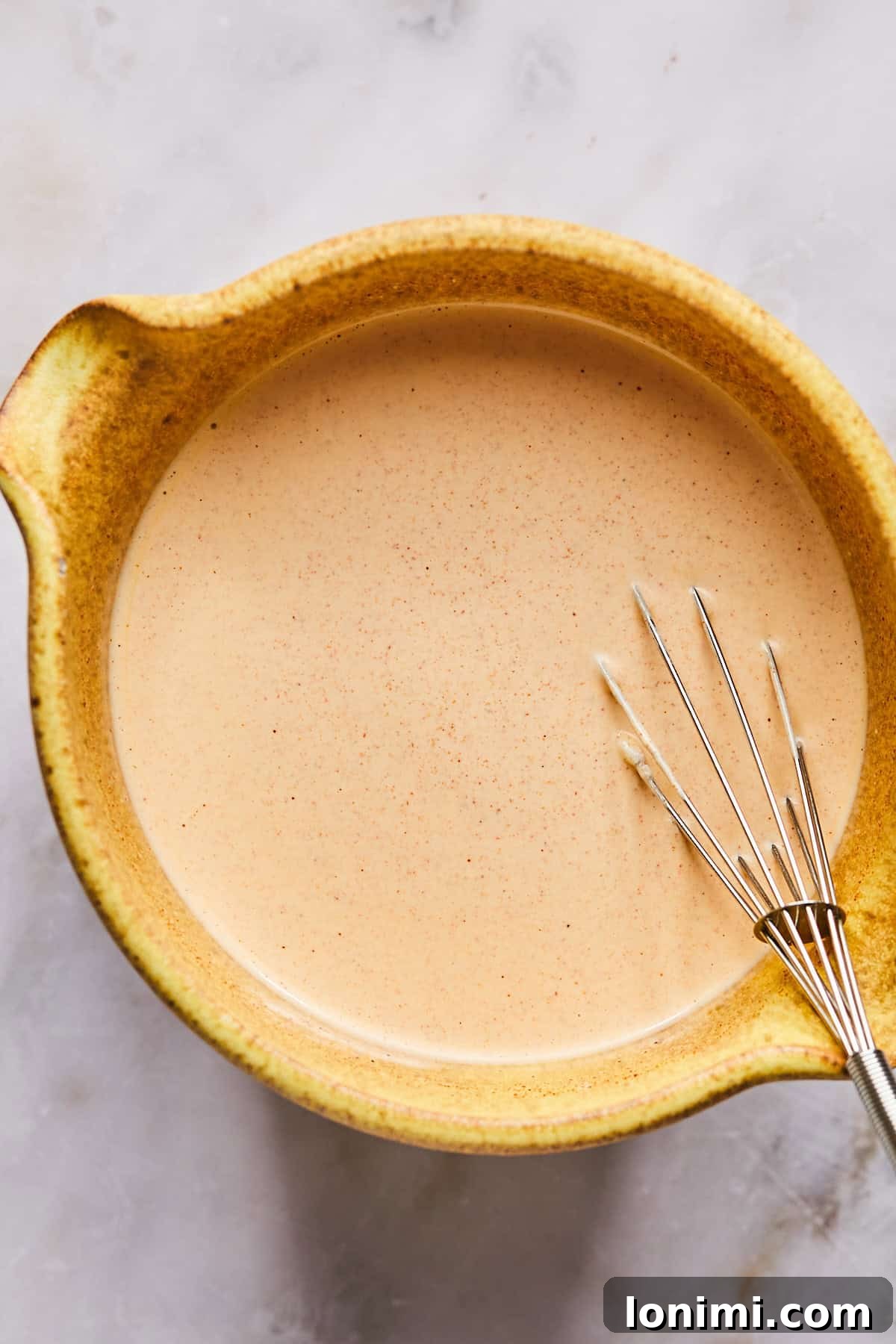 Creamy chipotle lime mayo sauce, freshly whisked and ready to be poured over the salad ingredients.