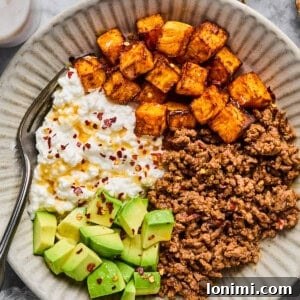 cottage cheese taco bowl with ground beef, cottage cheese, sweet potatoes, avocado and hot honey