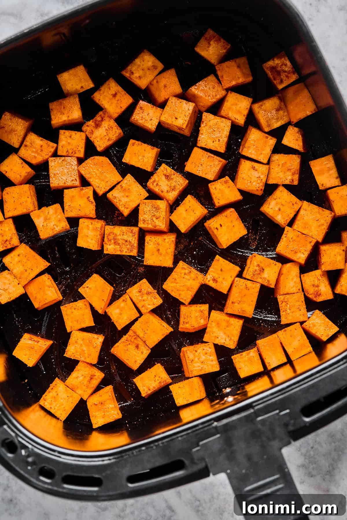 The Trending Protein Power Cottage Cheese Taco Bowl 4 sweet potato cubes cooking in an air fryer