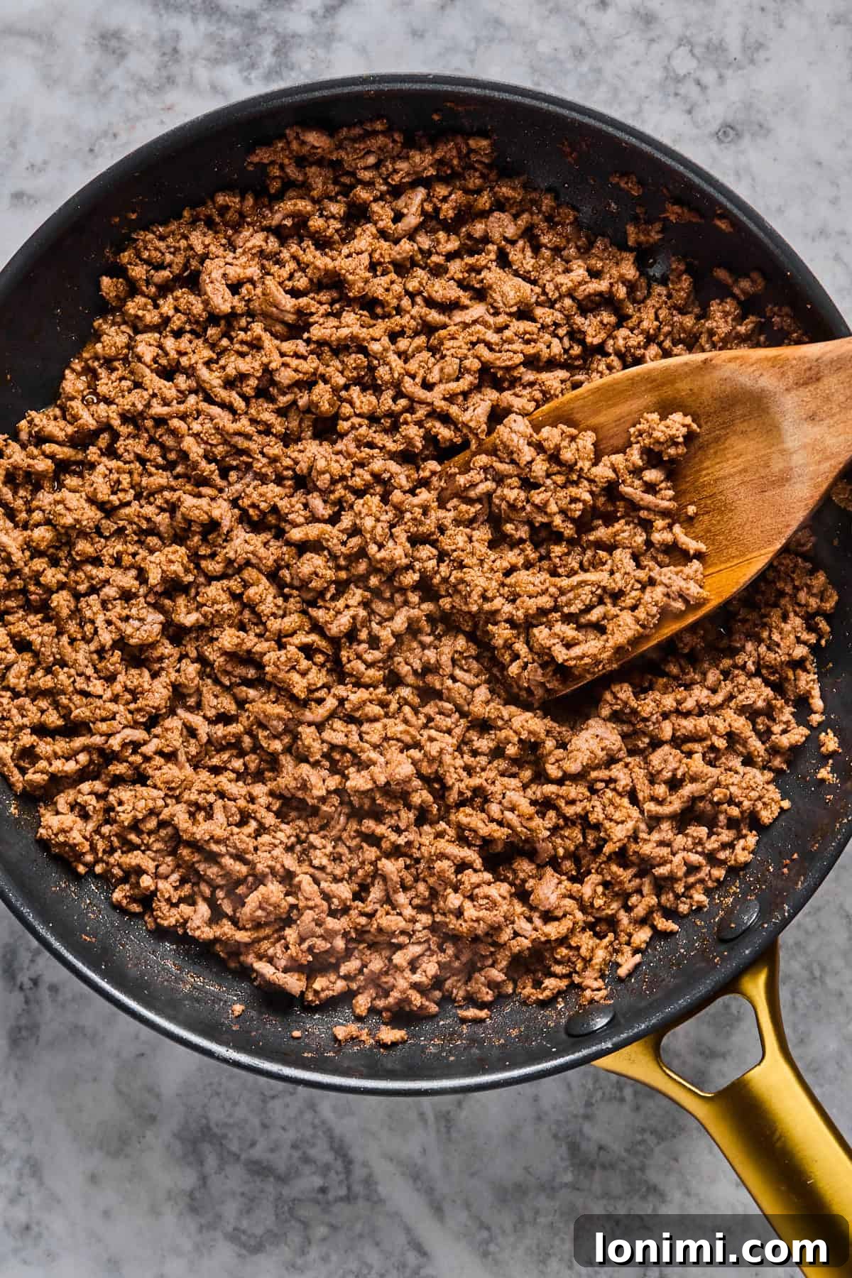 The Trending Protein Power Cottage Cheese Taco Bowl 6 browned taco meat in a skillet