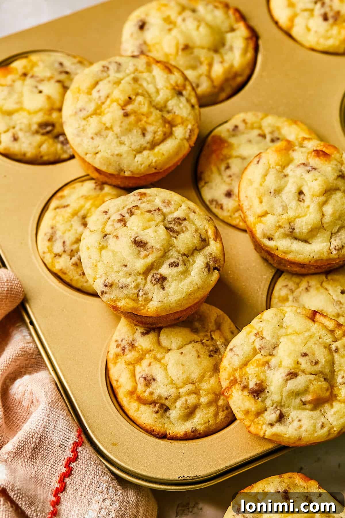 Close-up of McGriddle muffin stacked on top of a muffin tin, showcasing its golden exterior and inviting texture.