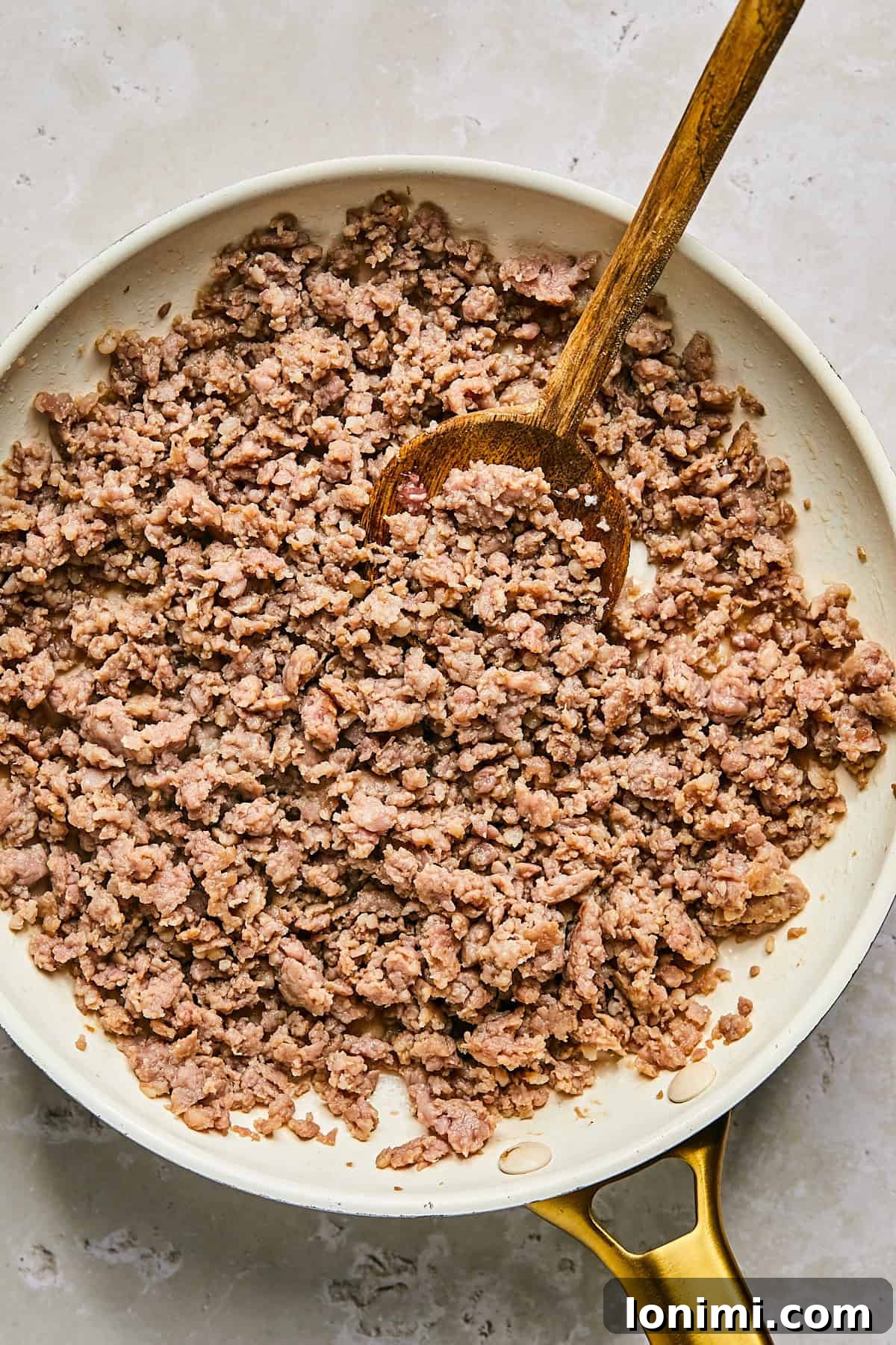 Browning breakfast sausage in a skillet for muffin batter