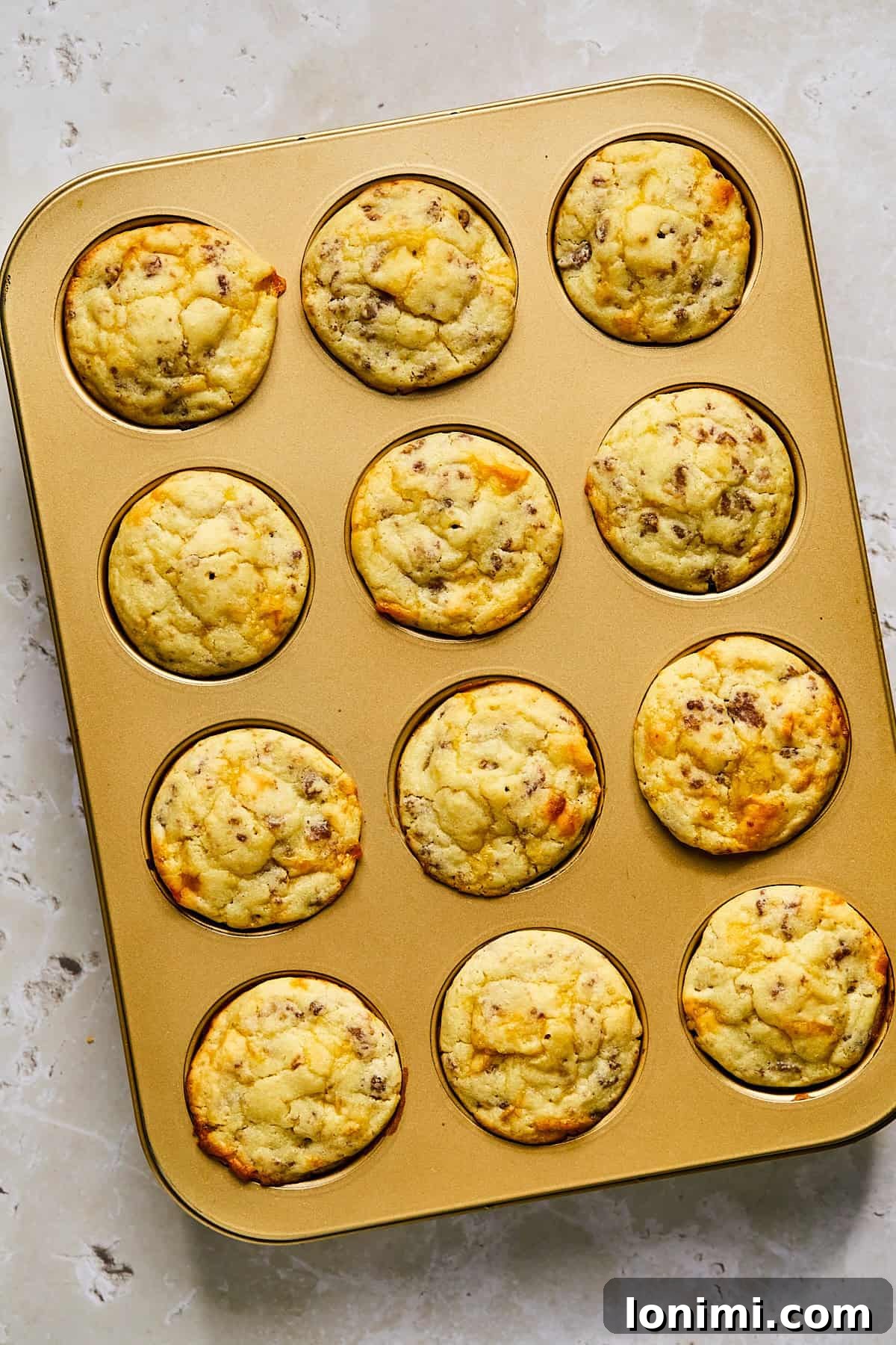Baked McGriddle muffins with golden tops cooling in the pan