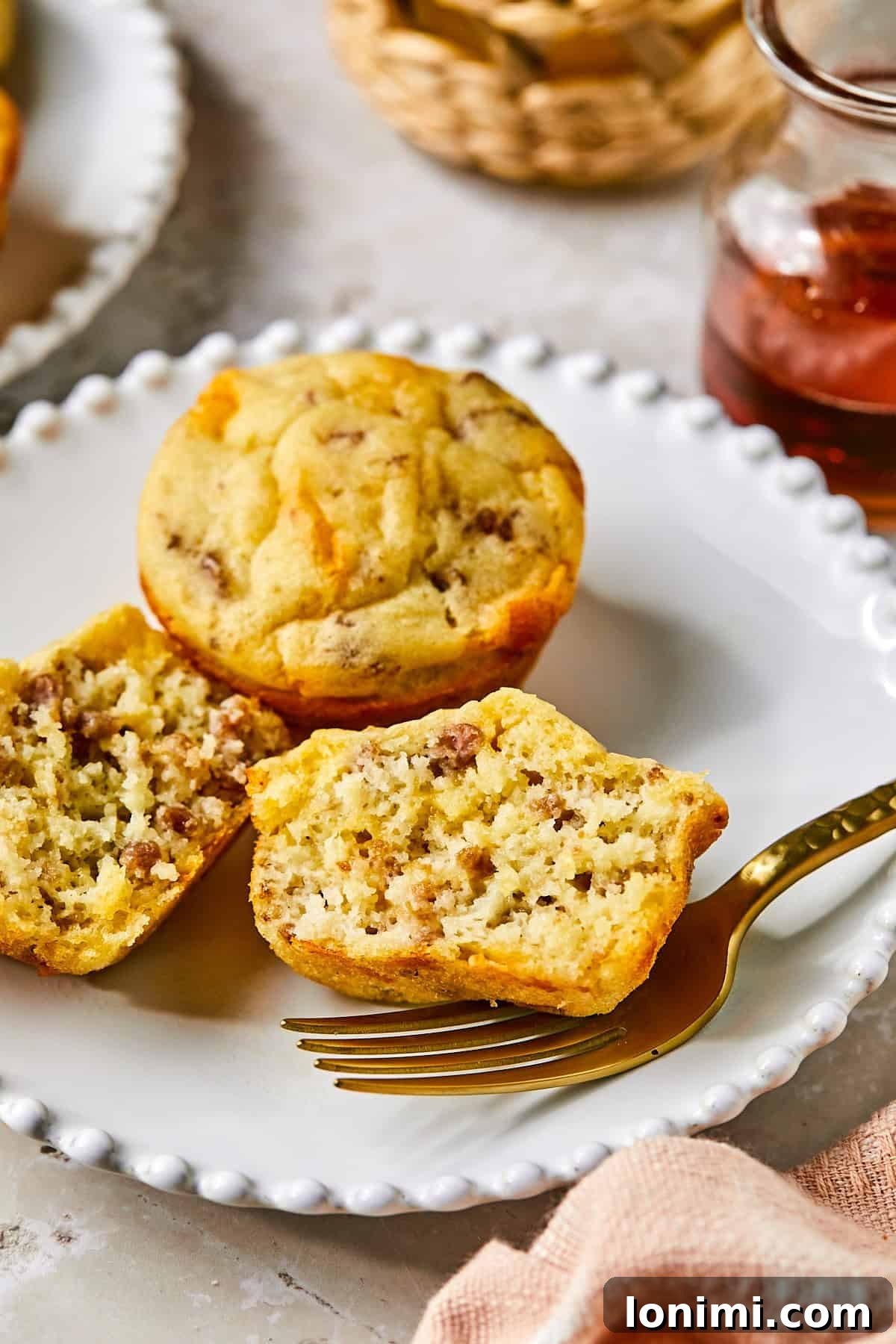 Side view of sliced McGriddle muffin showing savory sausage pieces and fluffy pancake texture inside.