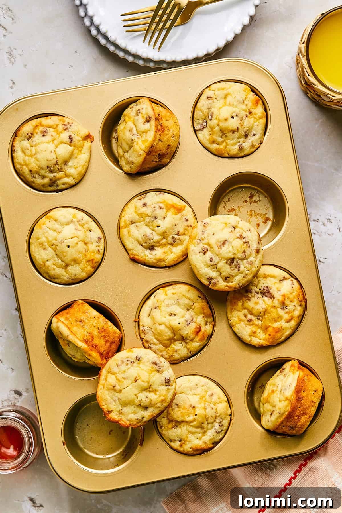 mcgriddle muffins baked in a gold muffin tin, showcasing their perfectly risen, golden tops.