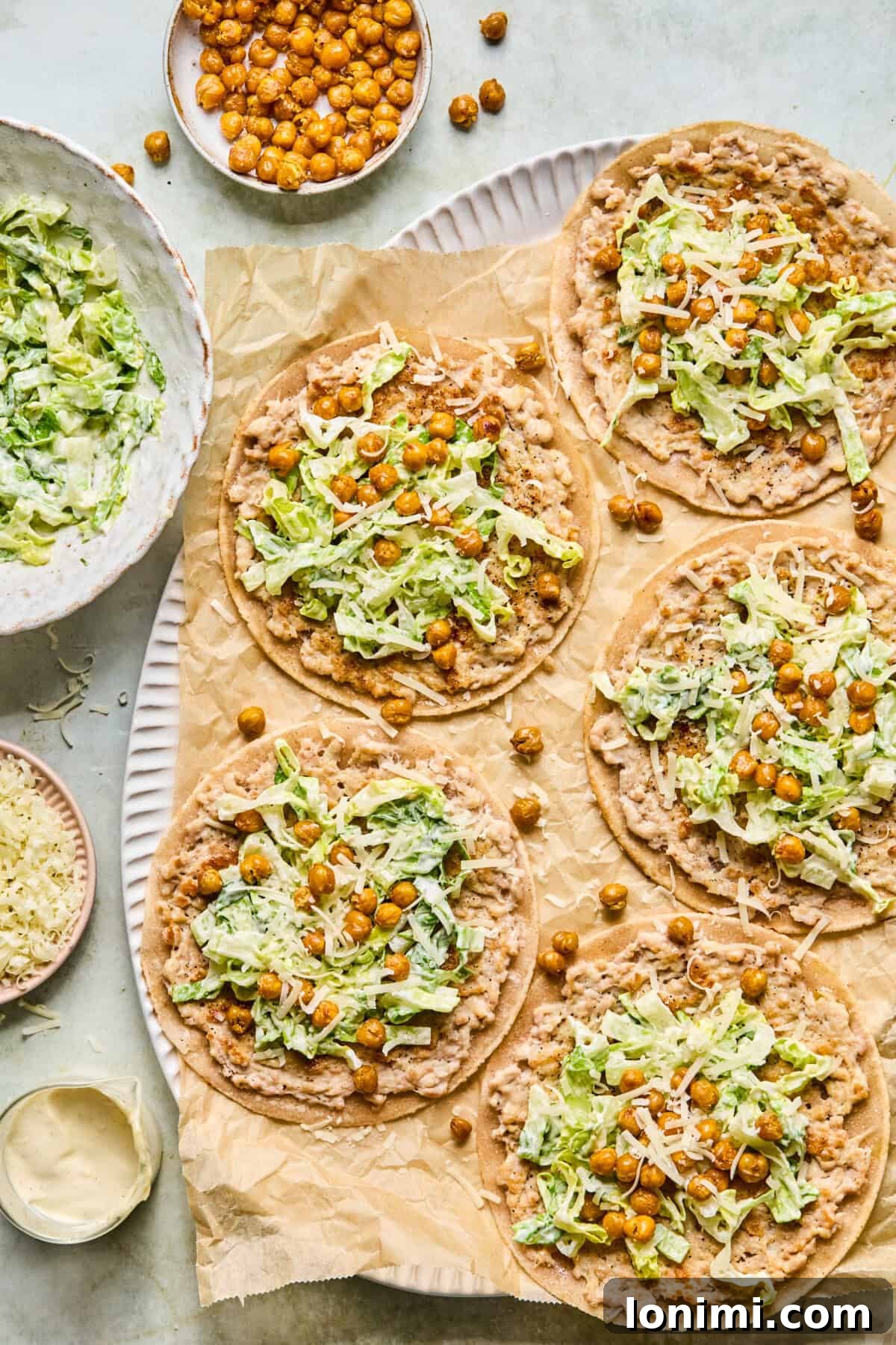 Crispy Chicken Caesar Smash Tacos served on tortillas with crunchy chickpeas and fresh romaine lettuce
