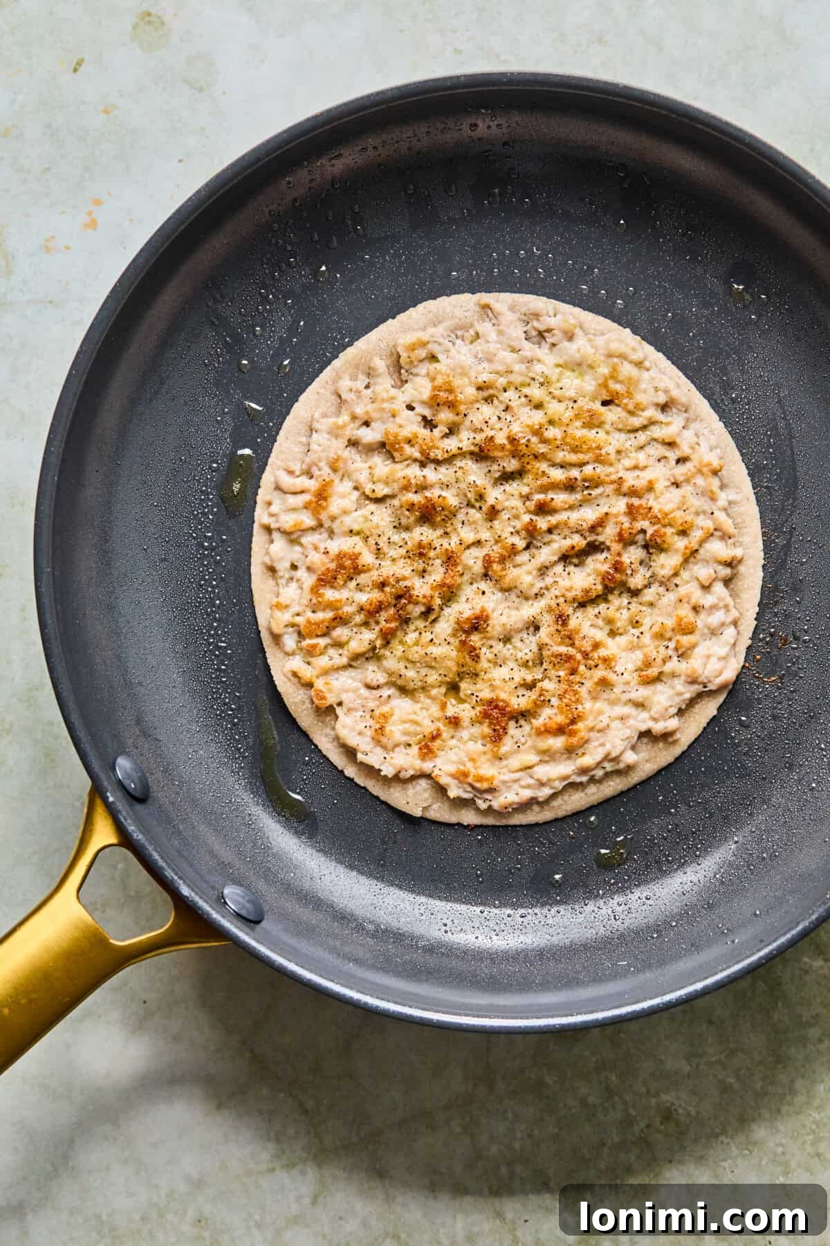 Step 6: A golden-brown tortilla with perfectly seared chicken resting in a cast iron pan.