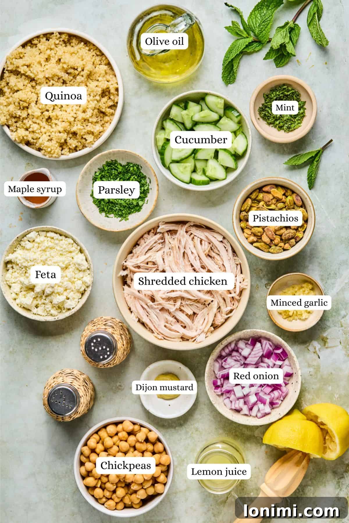 Jennifer Aniston's Go To High Protein Meal Prep Salad 3 overhead shot of fresh salad ingredients including quinoa, cucumber, chickpeas, and parsley