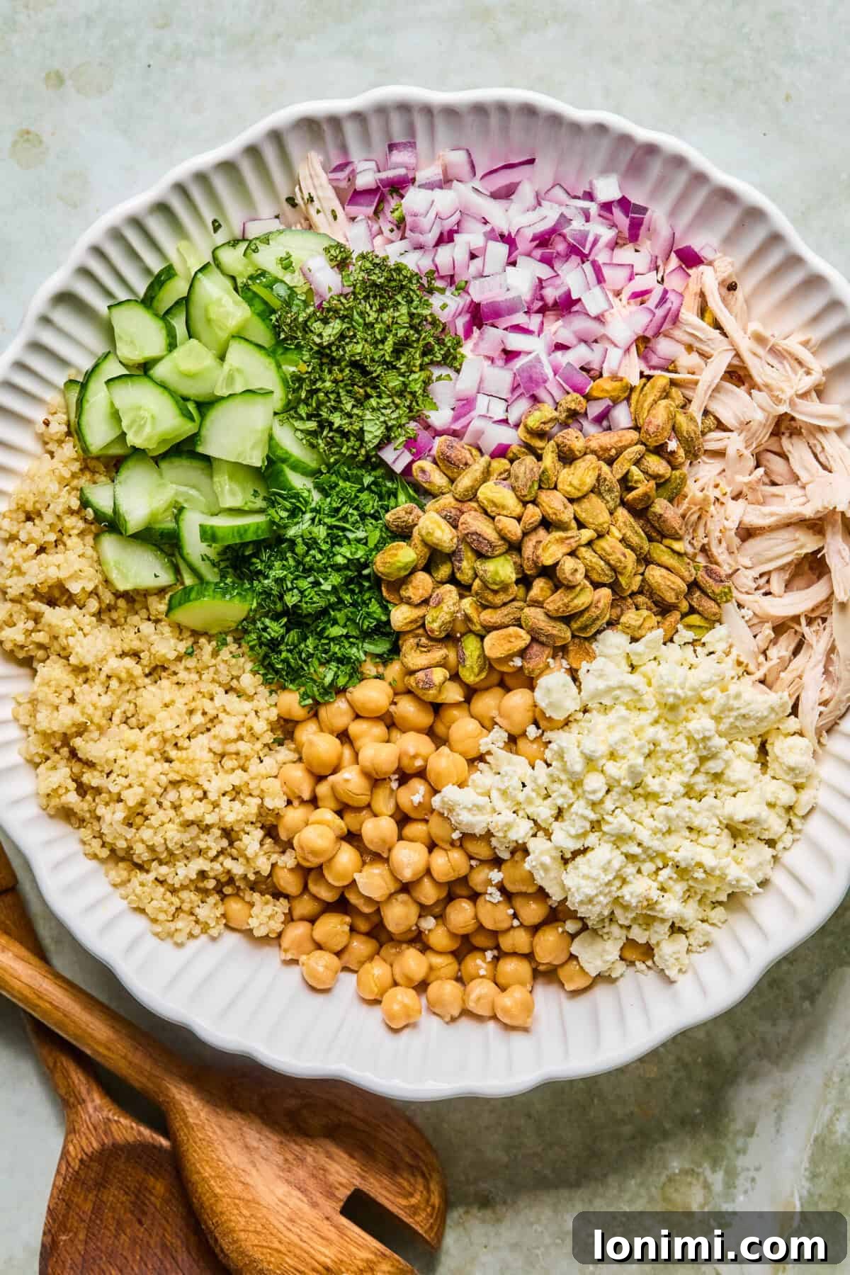 Jennifer Aniston's Go To High Protein Meal Prep Salad 5 step 2: salad ingredients together in a large white mixing bowl
