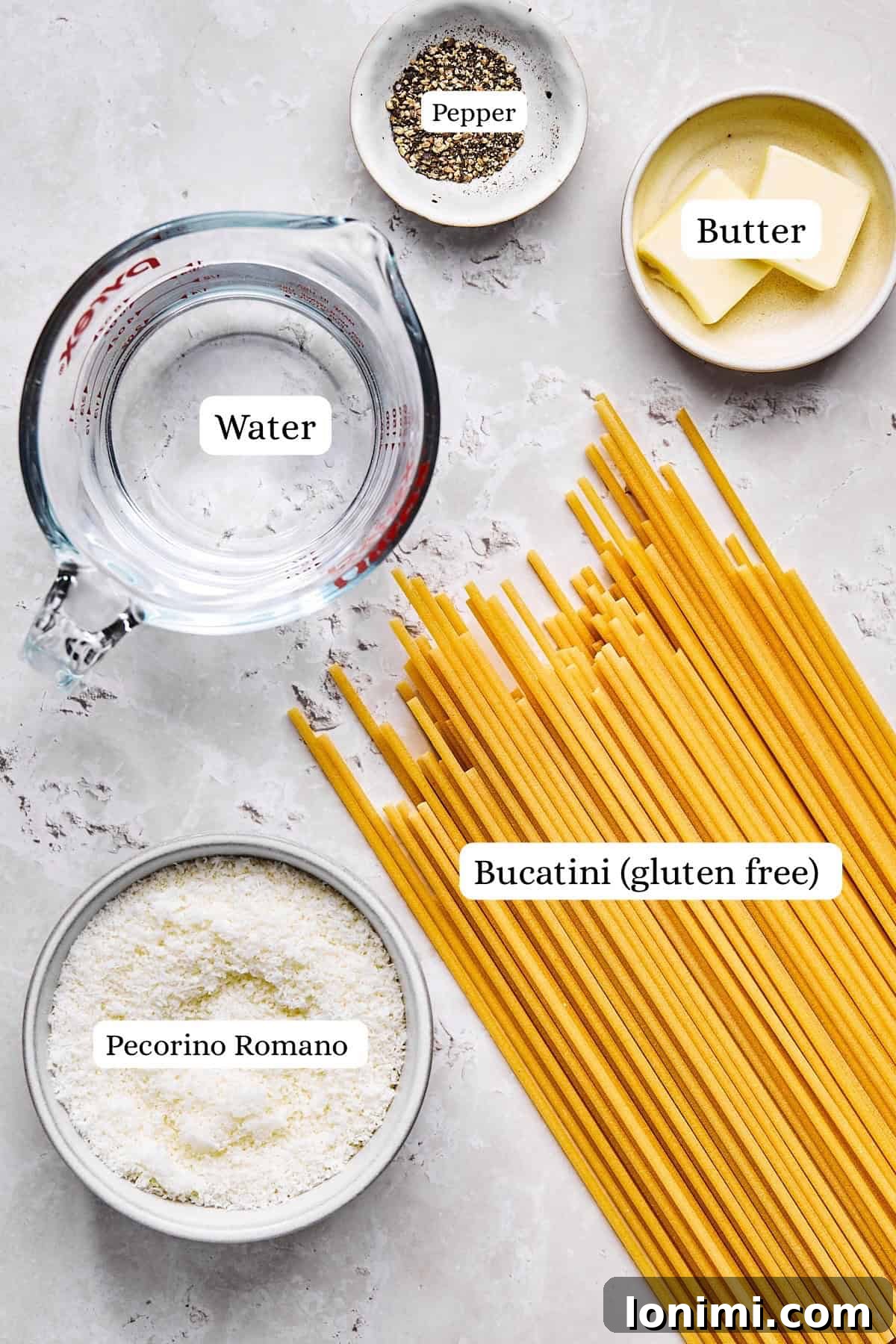 Ingredients for gluten-free cacio e pepe including Jovial bucatini, pecorino romano, butter, and black pepper