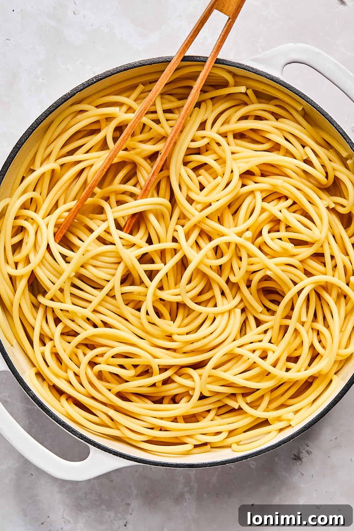 Bucatini pasta after boiling in a pot of salted water on the stove