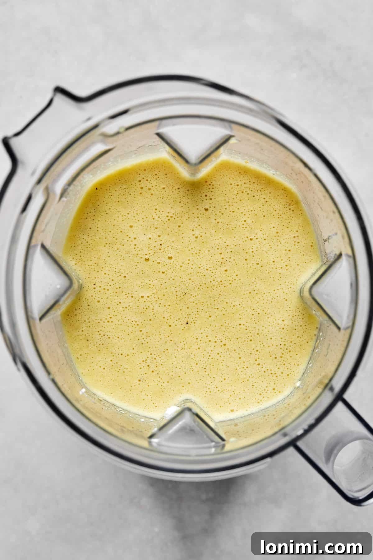 Blended egg and cottage cheese mixture, smooth and frothy in a glass blender