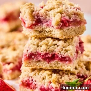 strawberry rhubarb crumble bars stacked on top of each other