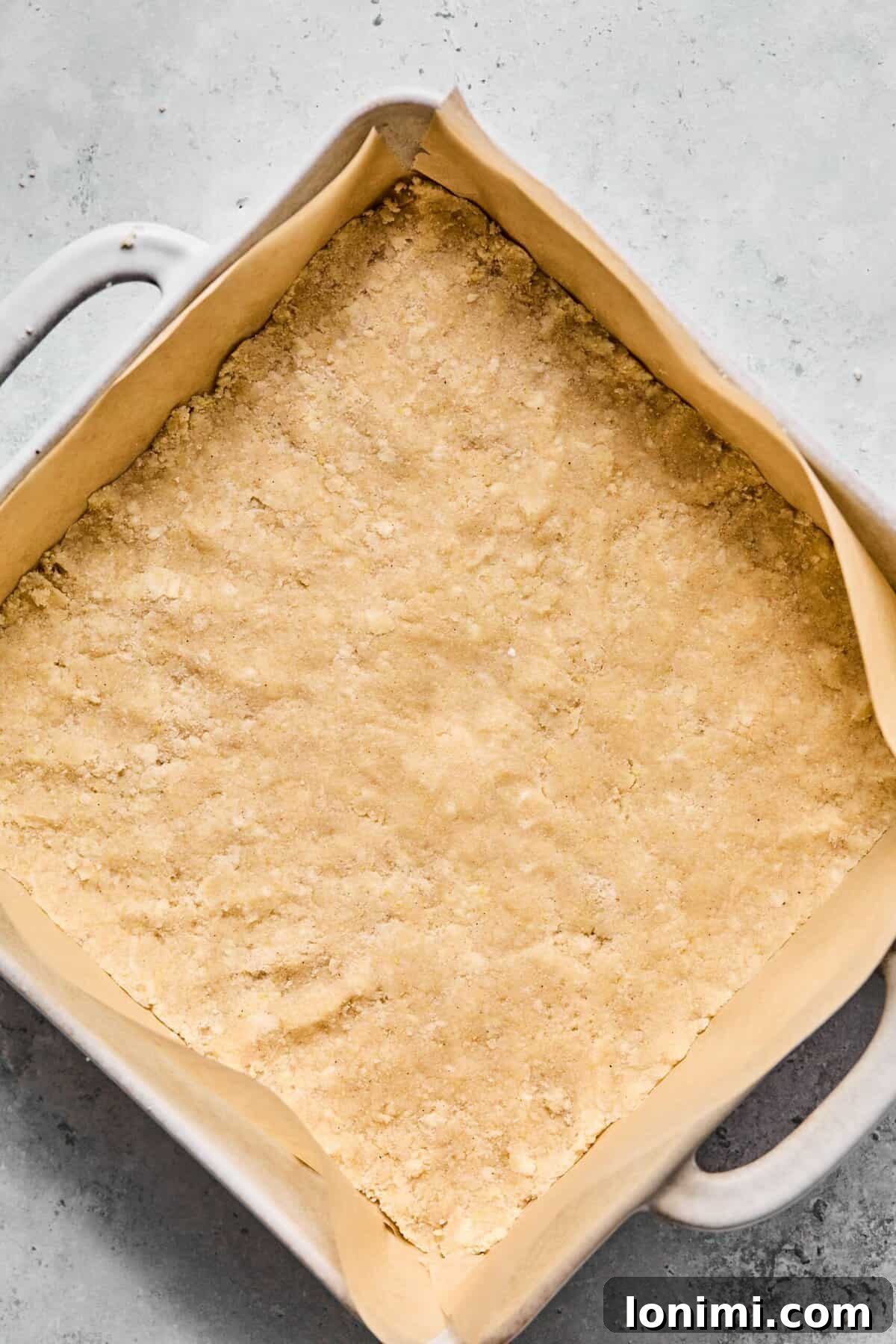 Pressed in half of the crumble dough into the bottom of a parchment-lined 9×9-inch pan