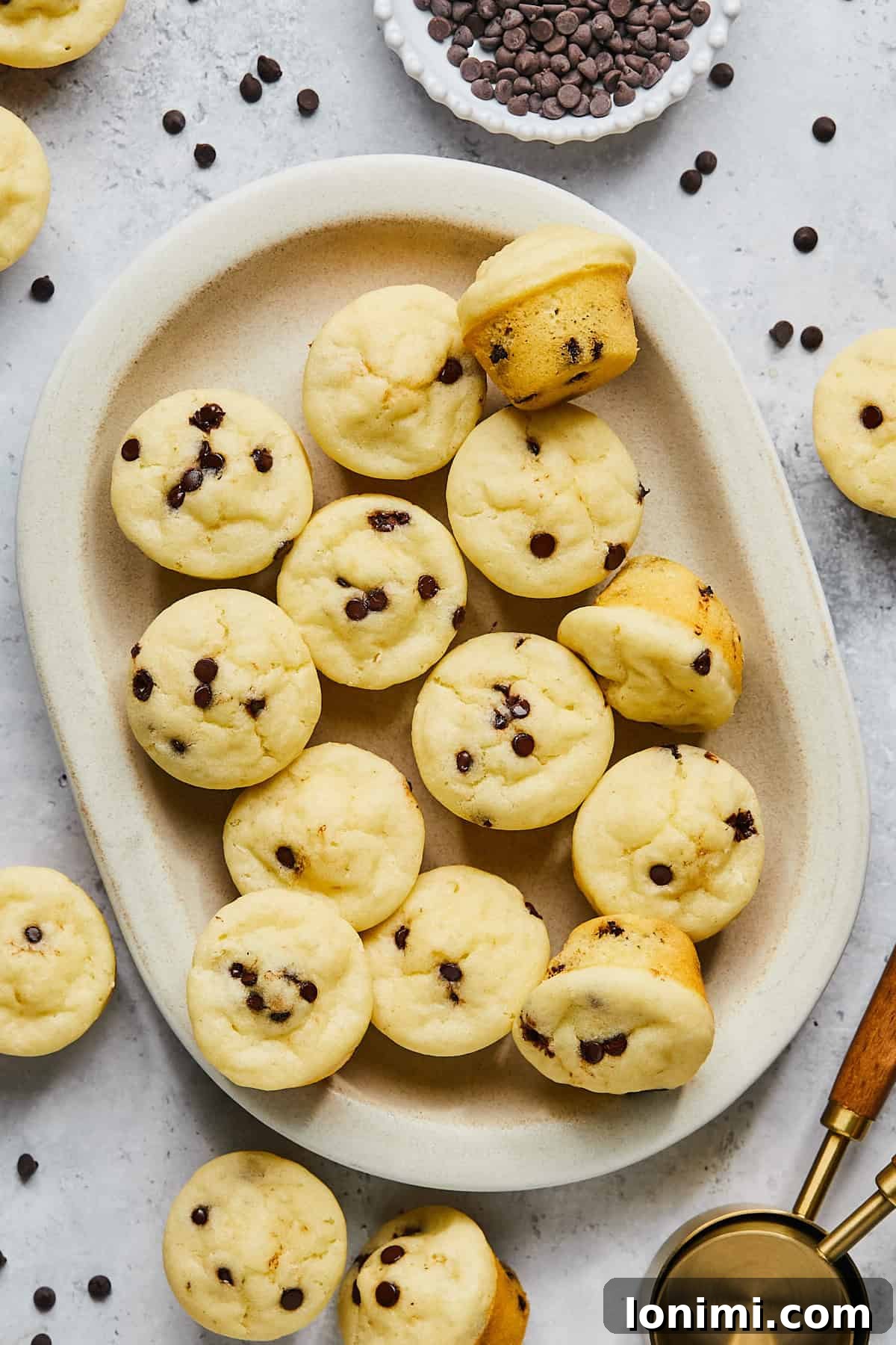 A full tray of perfectly baked gluten-free mini muffins, golden brown and ready to serve, showcasing their uniform size and inviting texture.