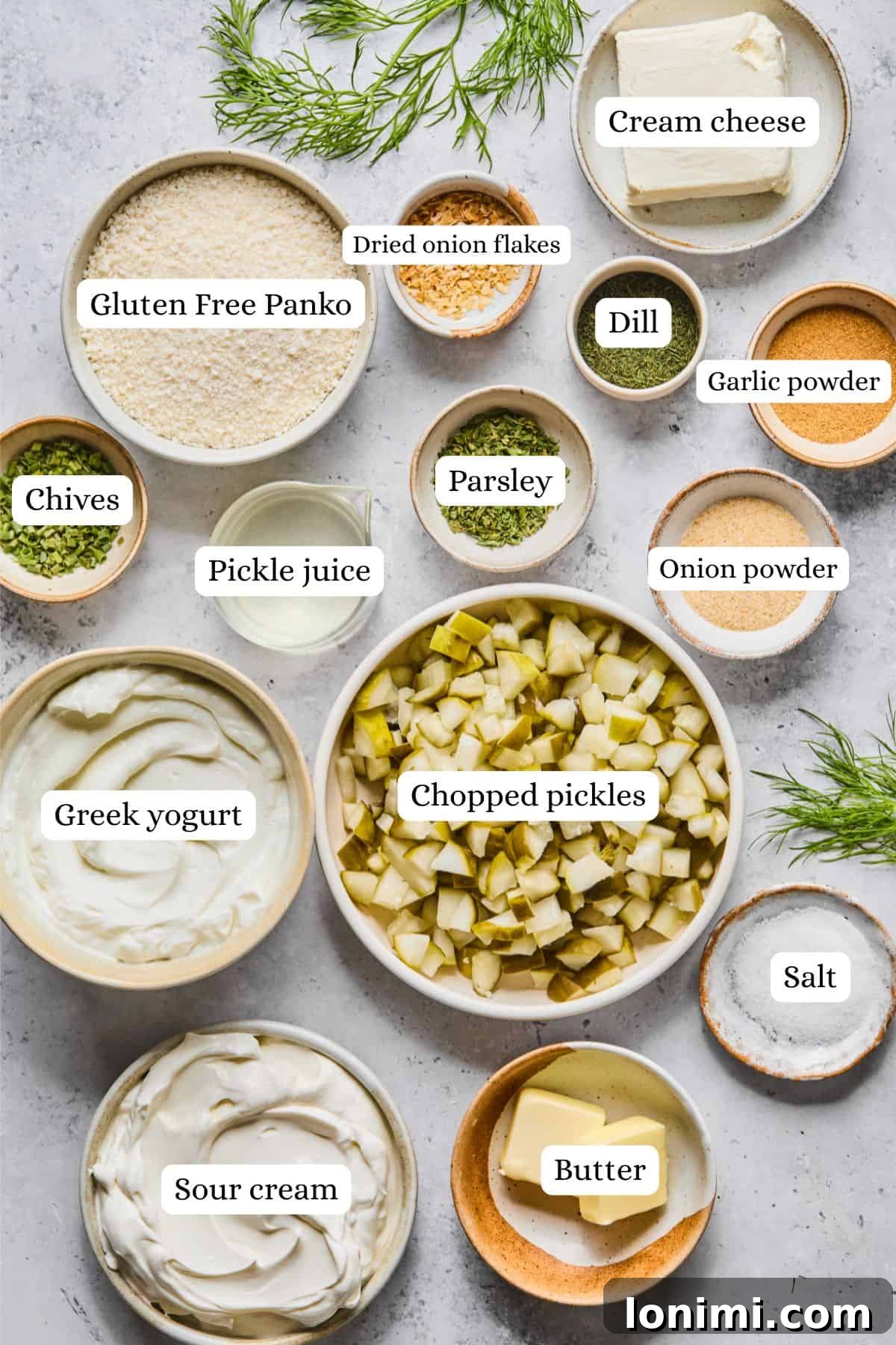 A beautiful flat lay of all the fresh ingredients needed for making delicious fried pickle dip, neatly arranged in small nesting bowls.