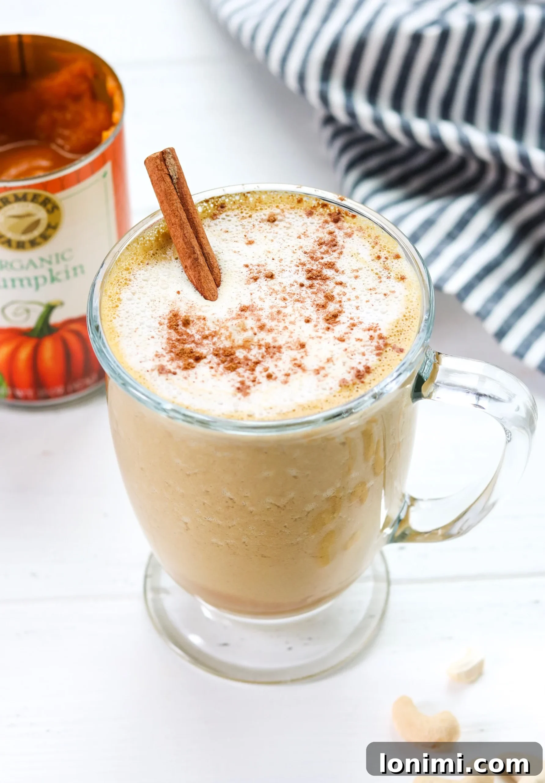 Creamy Cashew Pumpkin Spice Latte in a mug, garnished with cinnamon stick
