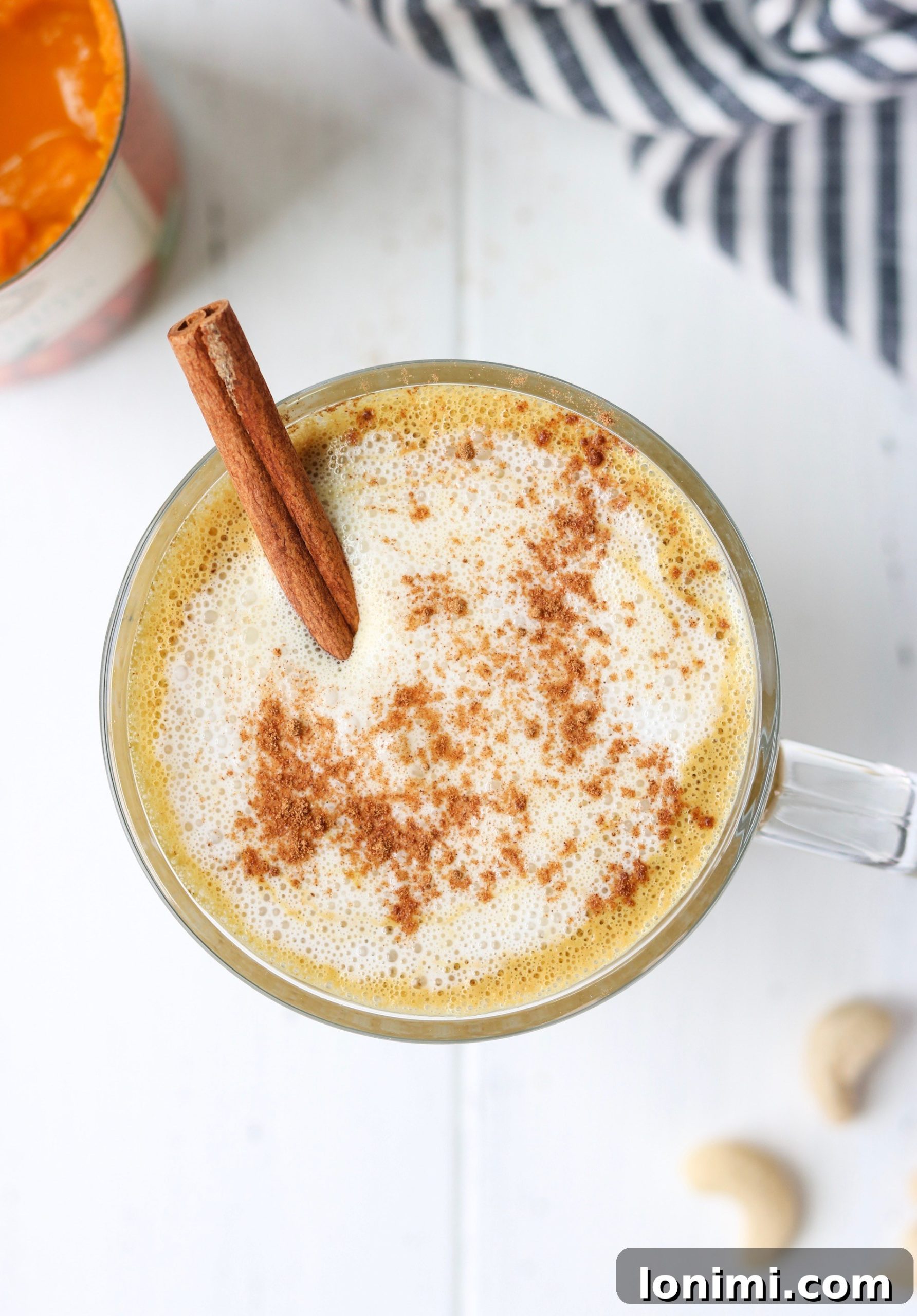 Closeup of a mug with Creamy Cashew Pumpkin Spice Latte, ready to be enjoyed