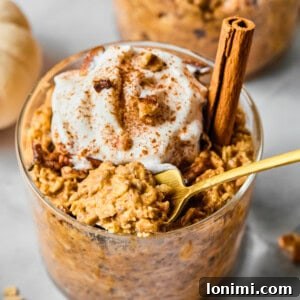 a close-up of pumpkin overnight oats with a gold spoon