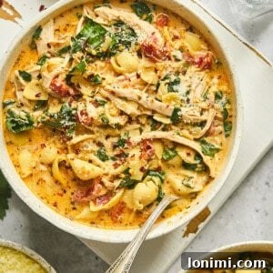 Marry Me Chicken Soup in a while bowl with a silver spoon