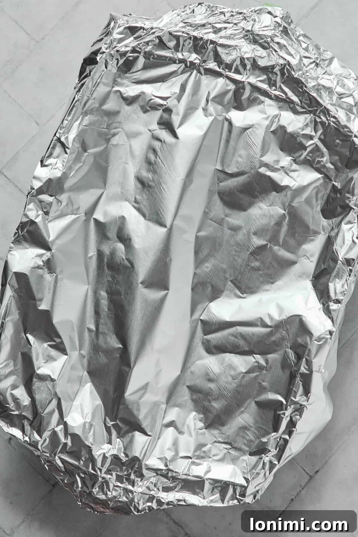 Baking dish covered with foil before going into the oven for the orzo bake.