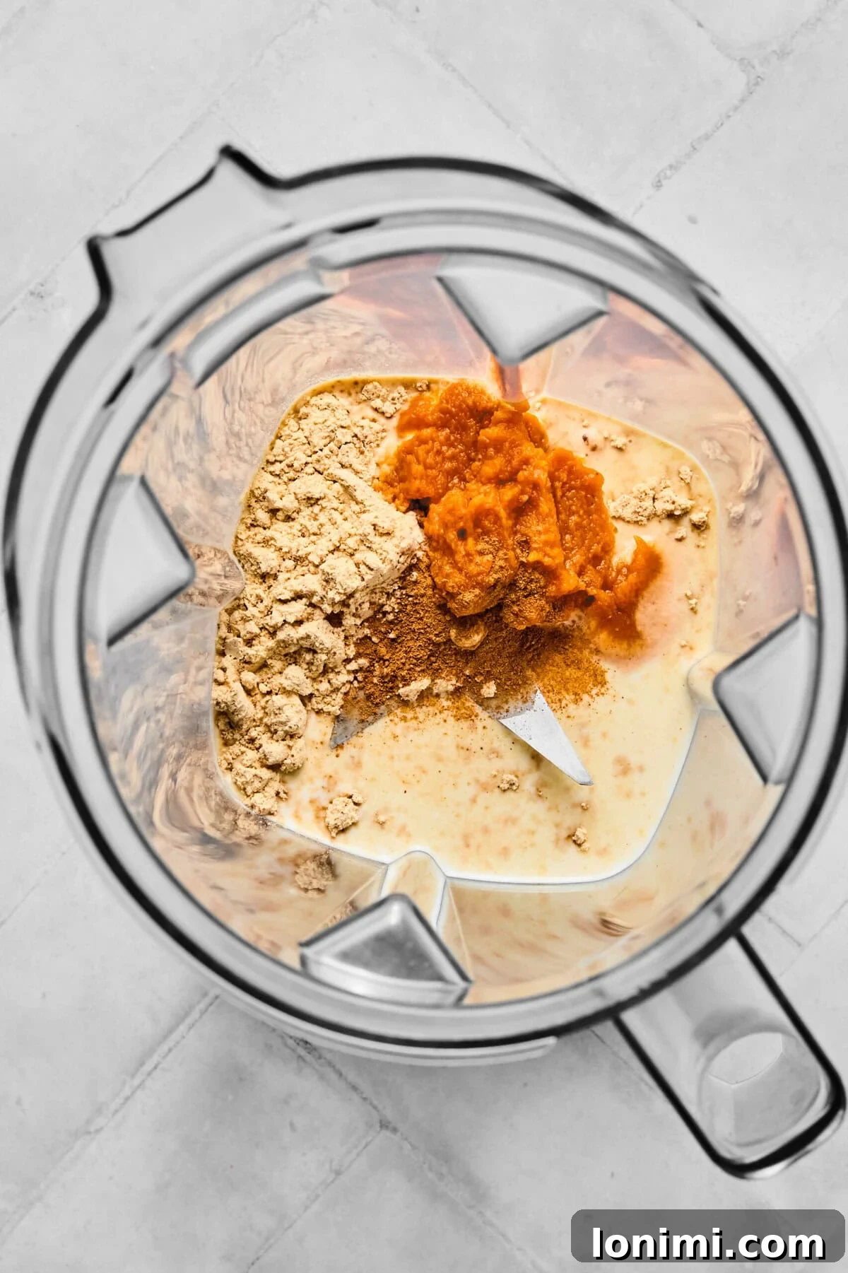Homemade Protein Pumpkin Cold Foam Perfection 4 Ingredients for pumpkin protein cold foam being combined in a frother or blender, ready for mixing.