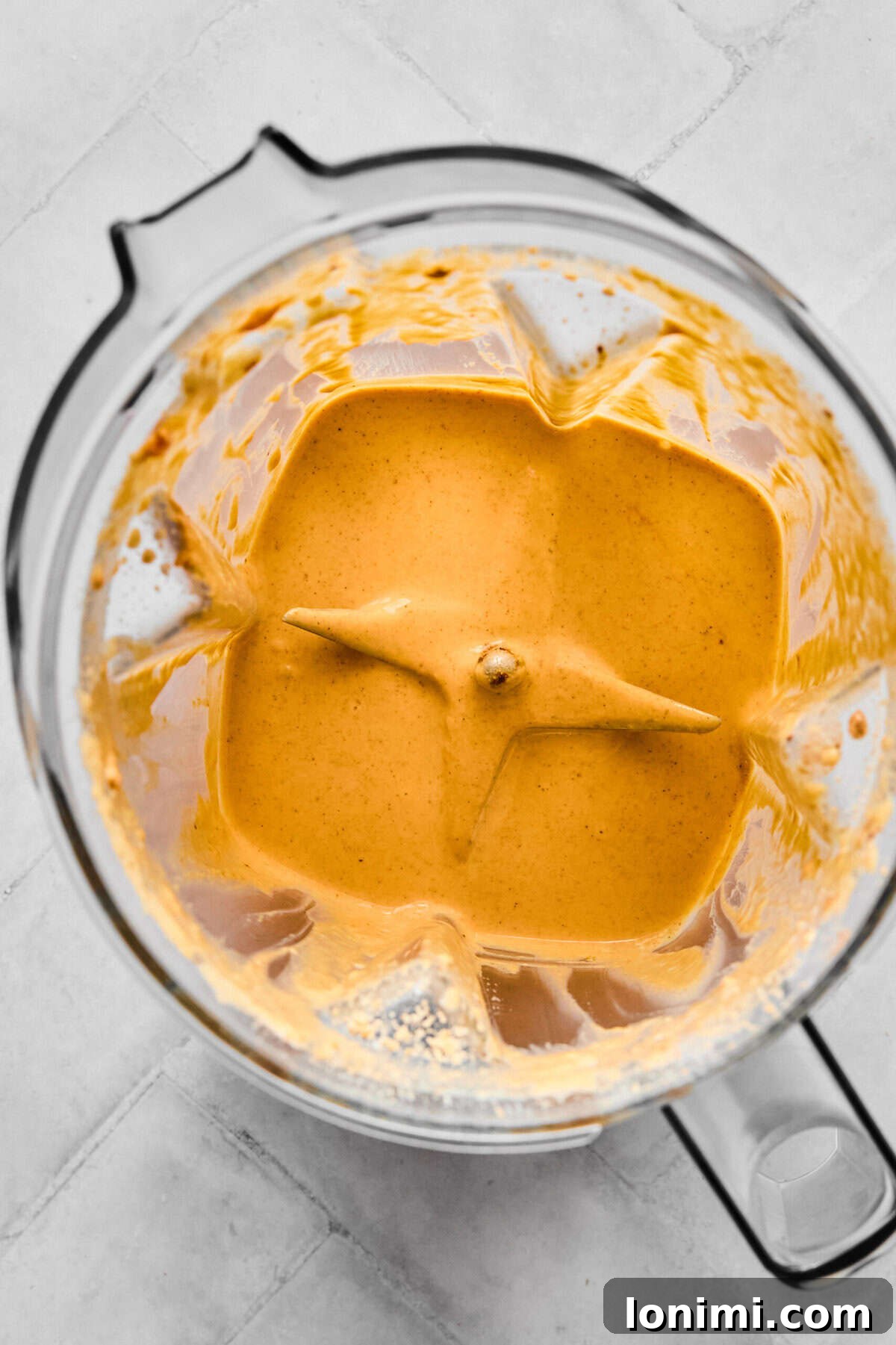 Homemade Protein Pumpkin Cold Foam Perfection 5 The pumpkin protein cold foam mixture blending in a frother, showing its transformation into a creamy, thick consistency.