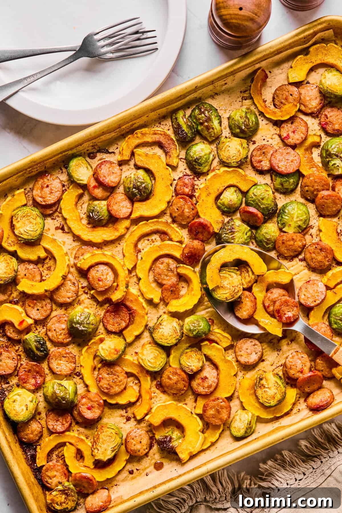 a side view of a delicata squash sheet pan dinner, showcasing the crispy texture and vibrant colors