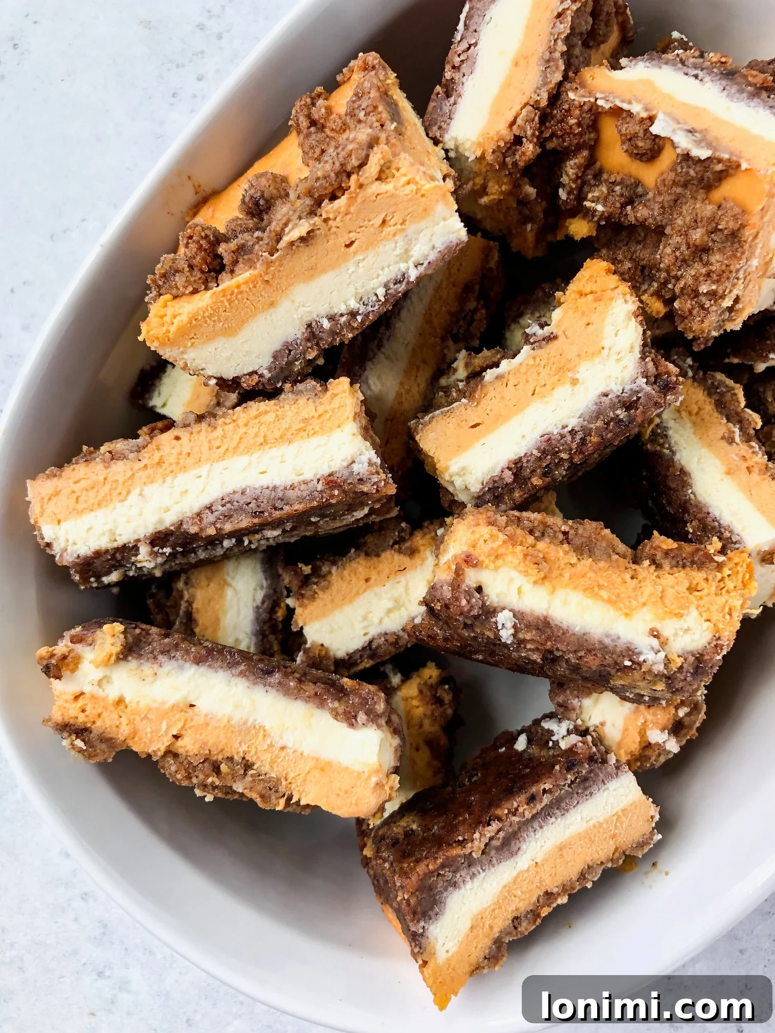 Decadent Grain Free Gluten Free Lactose Free Pumpkin Cheesecake Bars 5 Overhead shot of pumpkin cheesecake bars cooling, ready for refrigeration