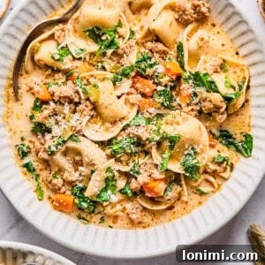 Slow Cooker Creamy Sausage Tortellini Soup 13 Sausage and tortellini soup in a white bowl