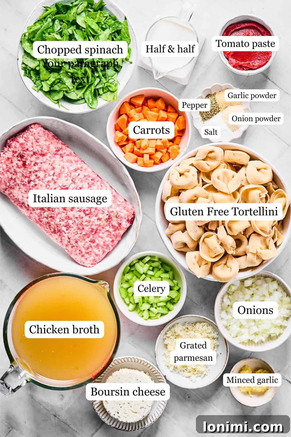 Slow Cooker Creamy Sausage Tortellini Soup 3 ingredients on a white surface including spinach, carrots, italian sausage, tortellini, seasonings, half and half, tomato paste, boursin cheese, chicken broth, celery, onions, and garlic