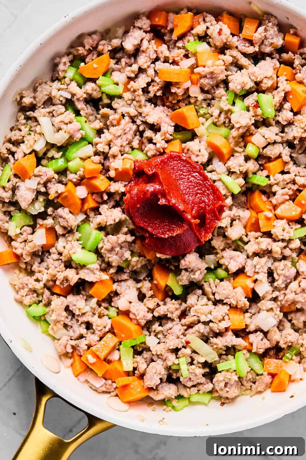 Slow Cooker Creamy Sausage Tortellini Soup 5 adding the veggies and tomato paste to the skillet