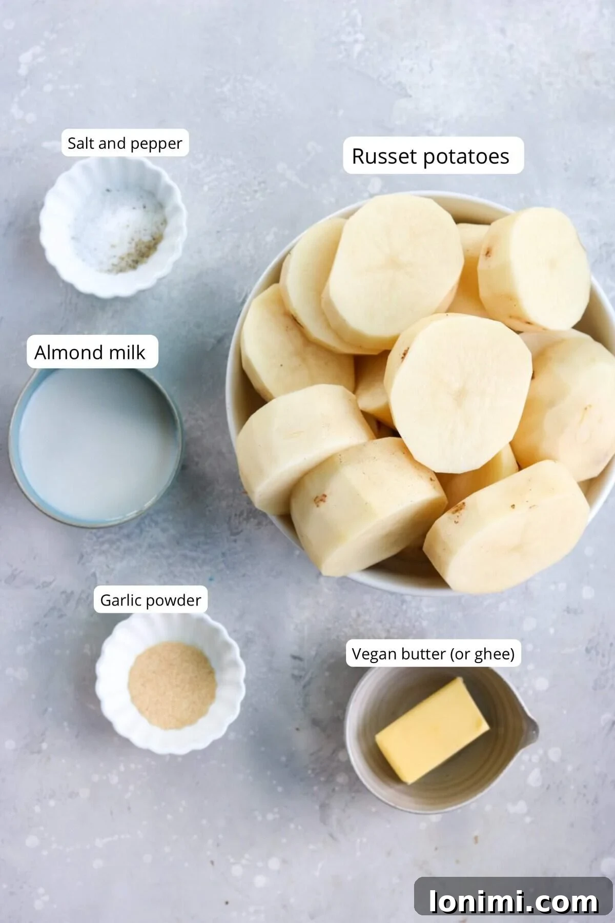Selection of ingredients for dairy free mashed potatoes, including potatoes, vegan butter, and plant milk