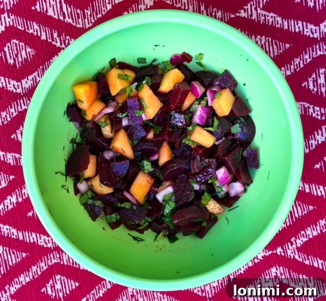 Vibrant Peachy Beet Salad in a white bowl, ready to serve.