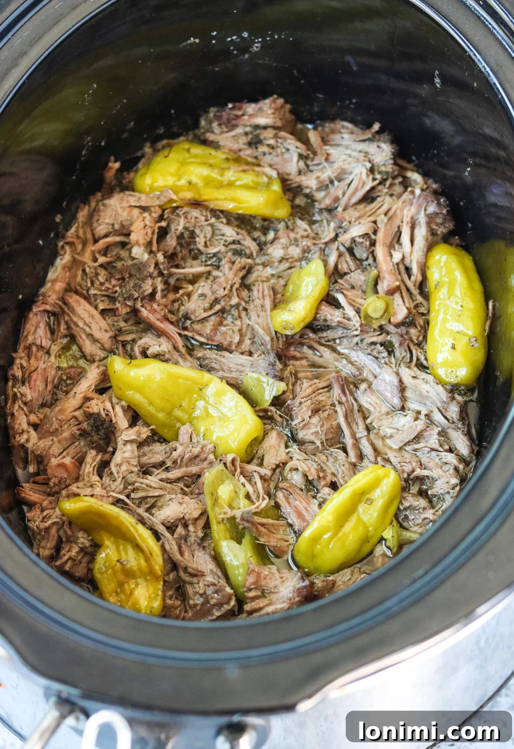 Slow Cooker Mississippi Pot Roast with tender beef and vibrant pepperoncinis