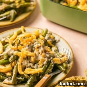 gluten free green bean casserole on a plate topped with fried onions