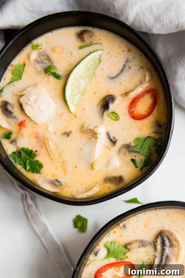 25 Hearty Whole30 Soups, Stews, and Chilis 21 A vibrant bowl of Best Ever Tom Kha Gai Soup, a Whole30 compliant Thai coconut chicken soup with mushrooms and herbs.