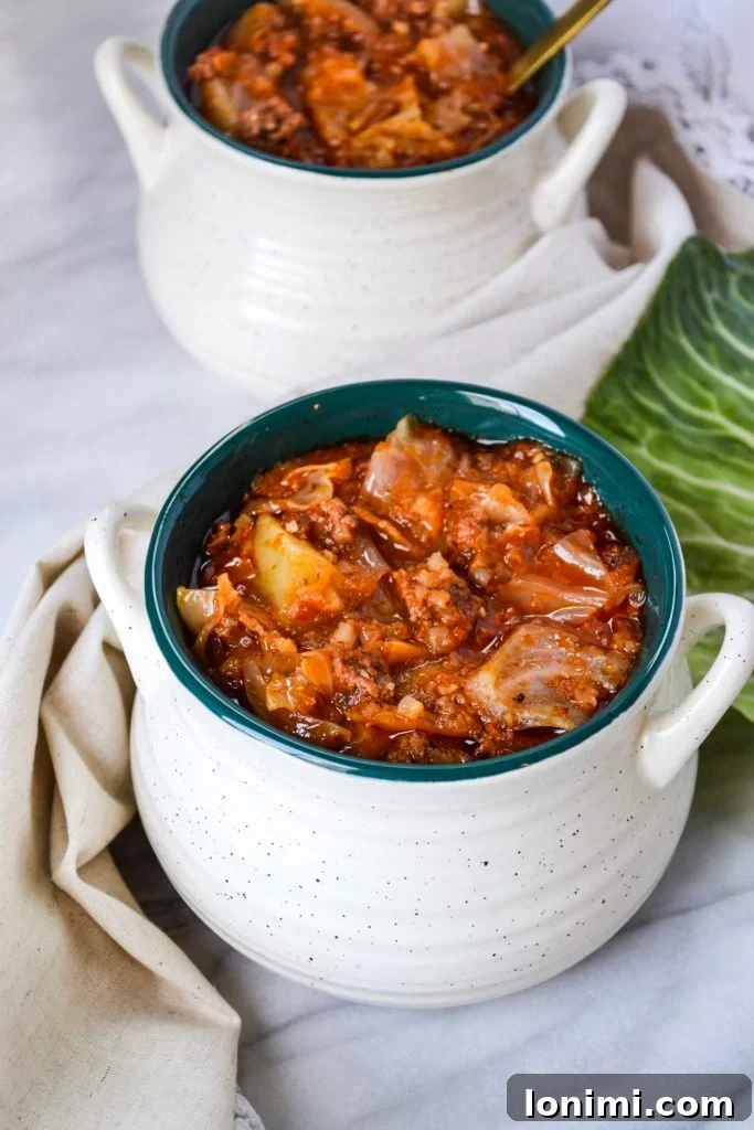 25 Hearty Whole30 Soups, Stews, and Chilis 7 A delicious bowl of Instant Pot Unstuffed Cabbage Soup, a healthy and comforting meal featuring ground meat and tender cabbage.