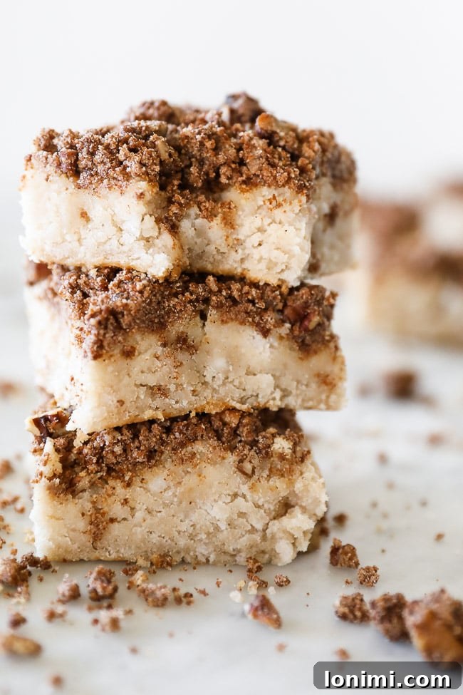 Delicious Gluten Free Coffee Cake with a crumbly topping, presented on a rustic wooden board.