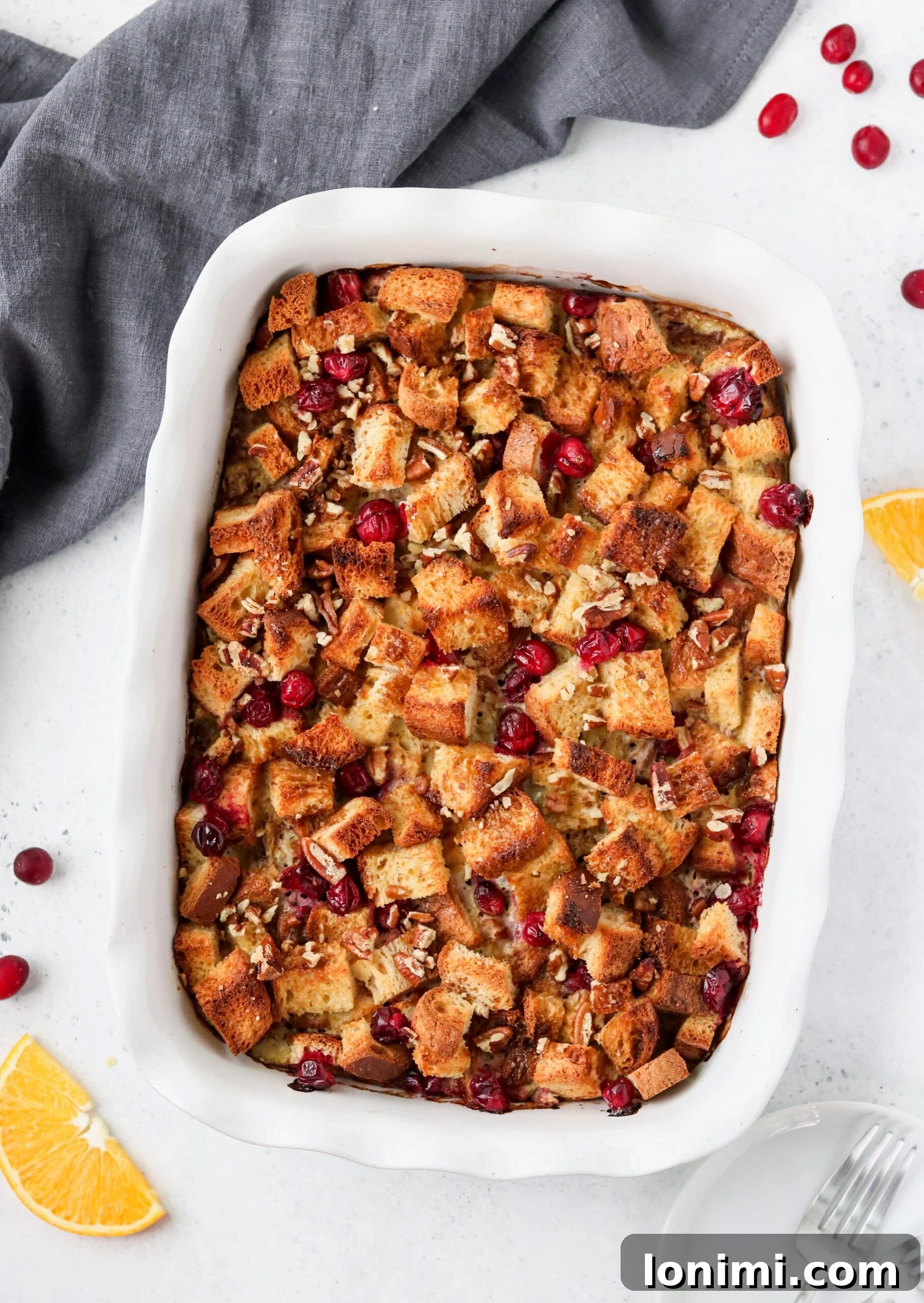 Zesty Orange Cranberry Overnight French Toast Bake Gluten and Dairy Free 3 Close-up of baked Orange Cranberry French Toast Casserole, showcasing golden-brown top and cranberries.