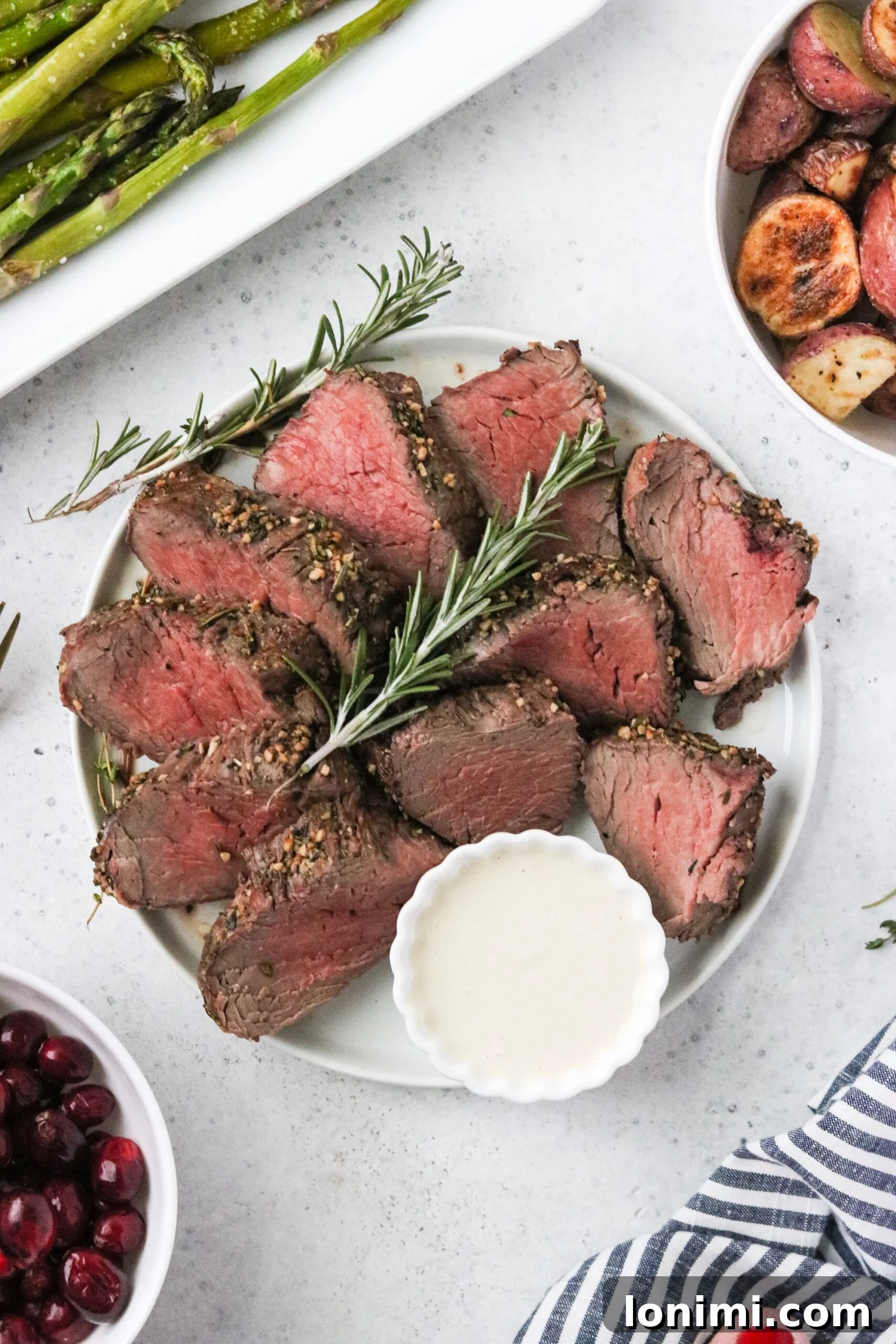 Pan-Seared Beef Tenderloin with Zesty Dairy-Free Horseradish Sauce 2 Perfectly roasted beef tenderloin on a platter