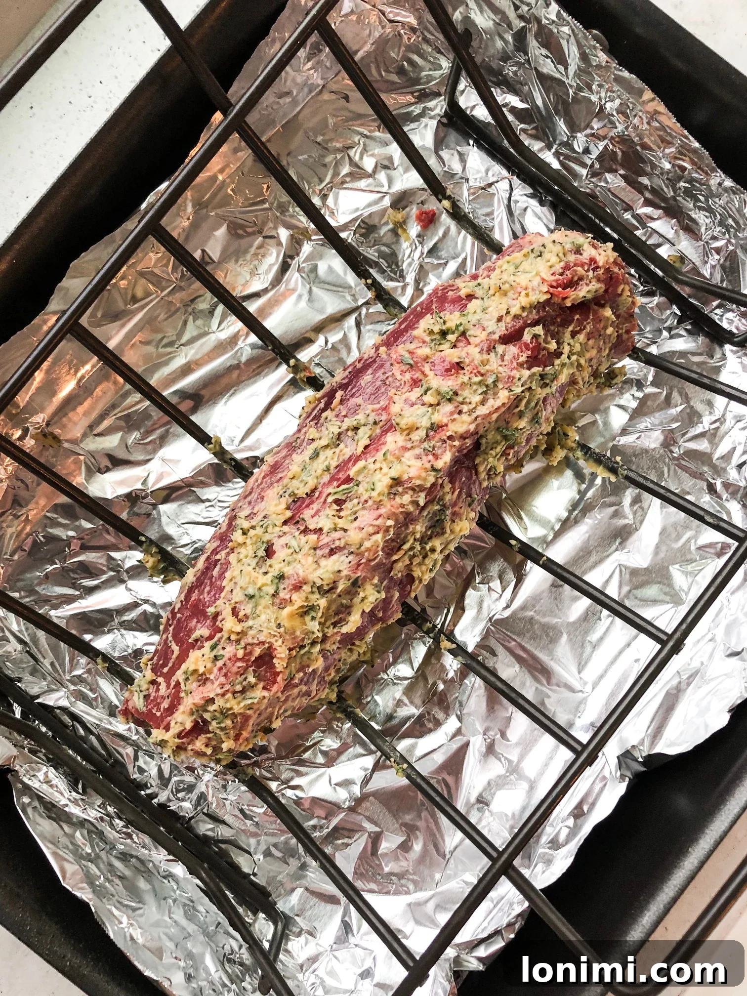 Pan-Seared Beef Tenderloin with Zesty Dairy-Free Horseradish Sauce 4 Beef tenderloin being trimmed on a cutting board