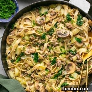 Quick and Flavorful Gluten-Free Sausage and Fennel Pasta 7 Sausage and fennel pasta in a cast iron skillet with a green napkin next to it