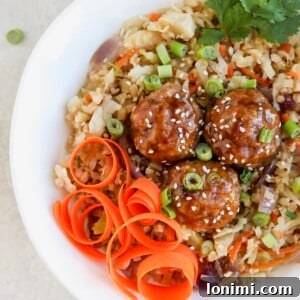 Asian pork meatball bowls with fried rice and carrot spirals