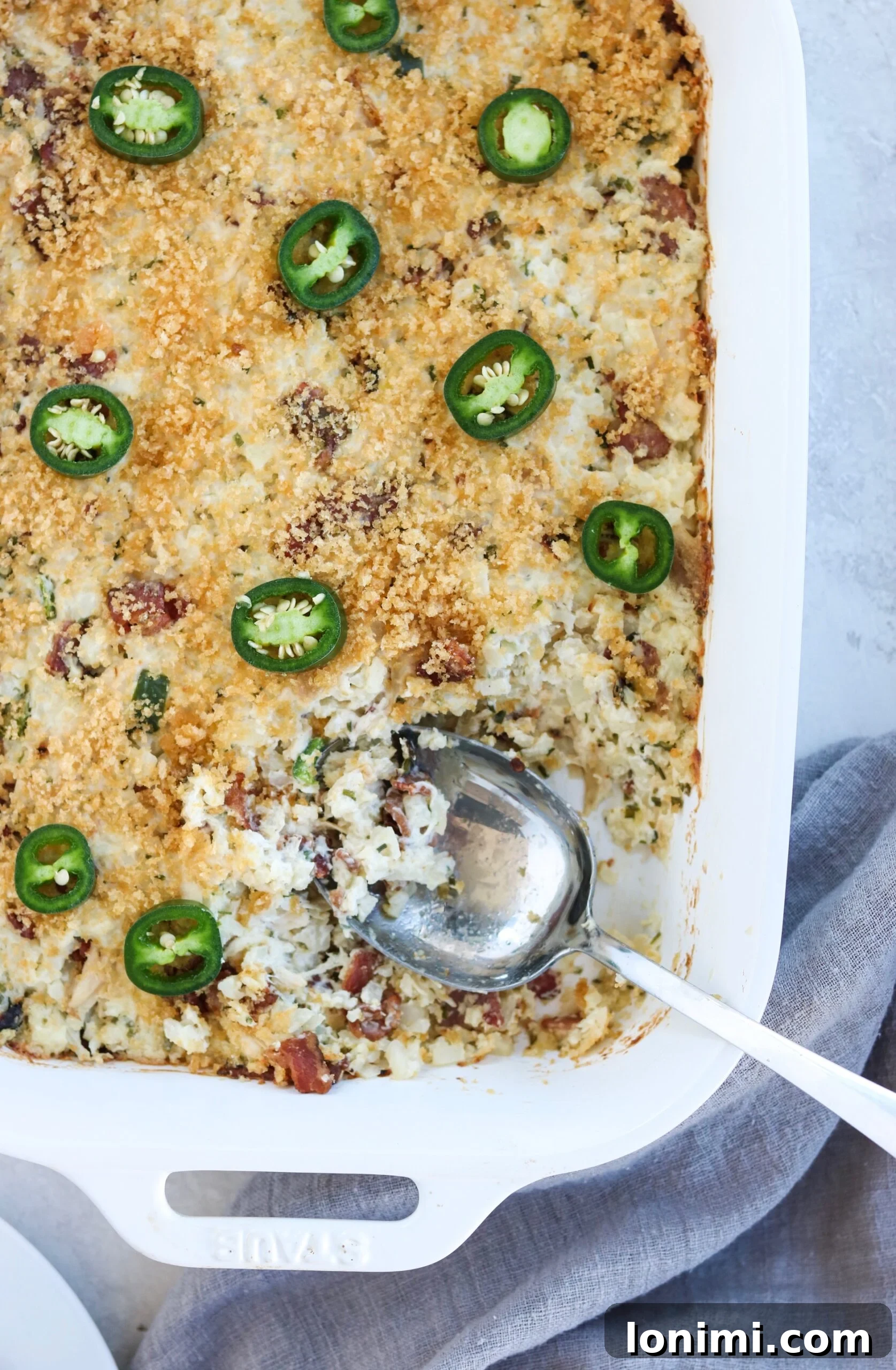 Closeup of the finished Bacon Jalapeno Popper Chicken Casserole, garnished with fresh cilantro and ready to be served.