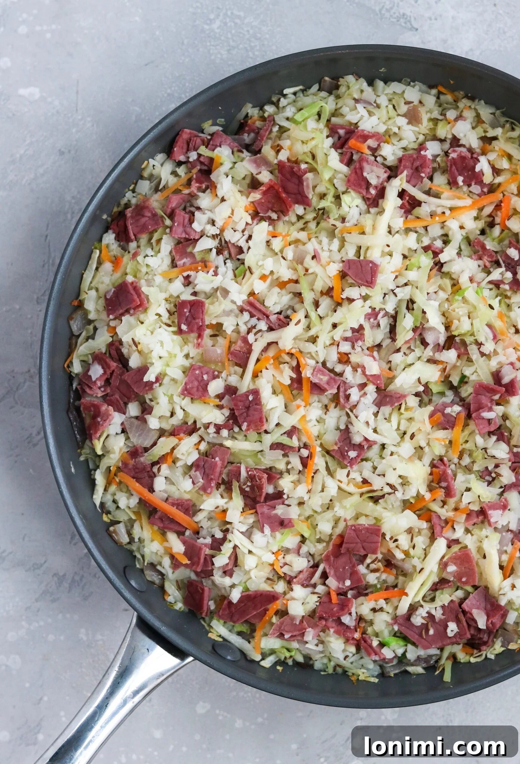 Keto Paleo Reuben Bowl 3 Close-up of a vibrant Reuben in a Bowl with shredded cabbage, corned beef, and a creamy dressing, showcasing its rich texture.