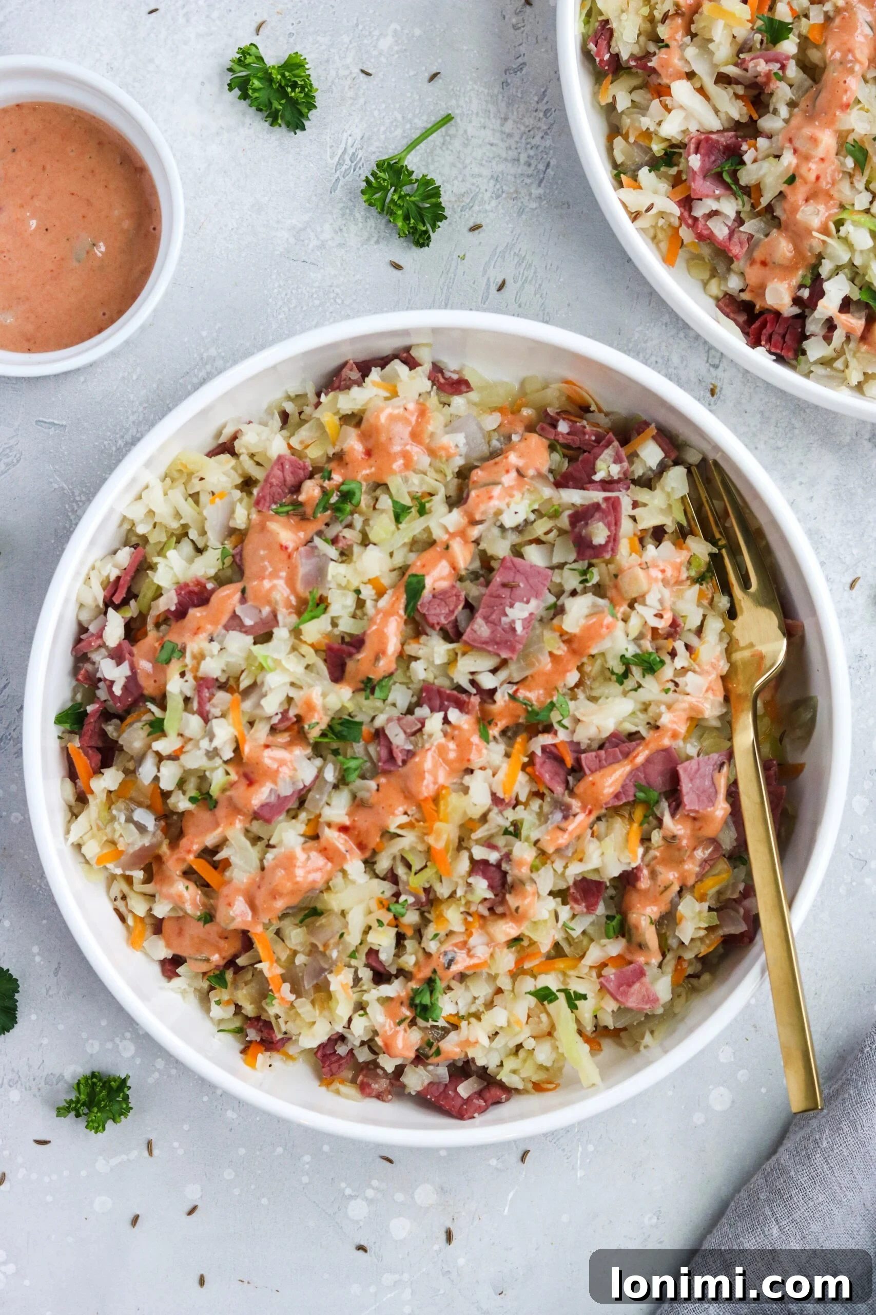 Keto Paleo Reuben Bowl 5 A serving of Reuben in a Bowl, garnished with fresh dill and a generous drizzle of Thousand Island dressing.