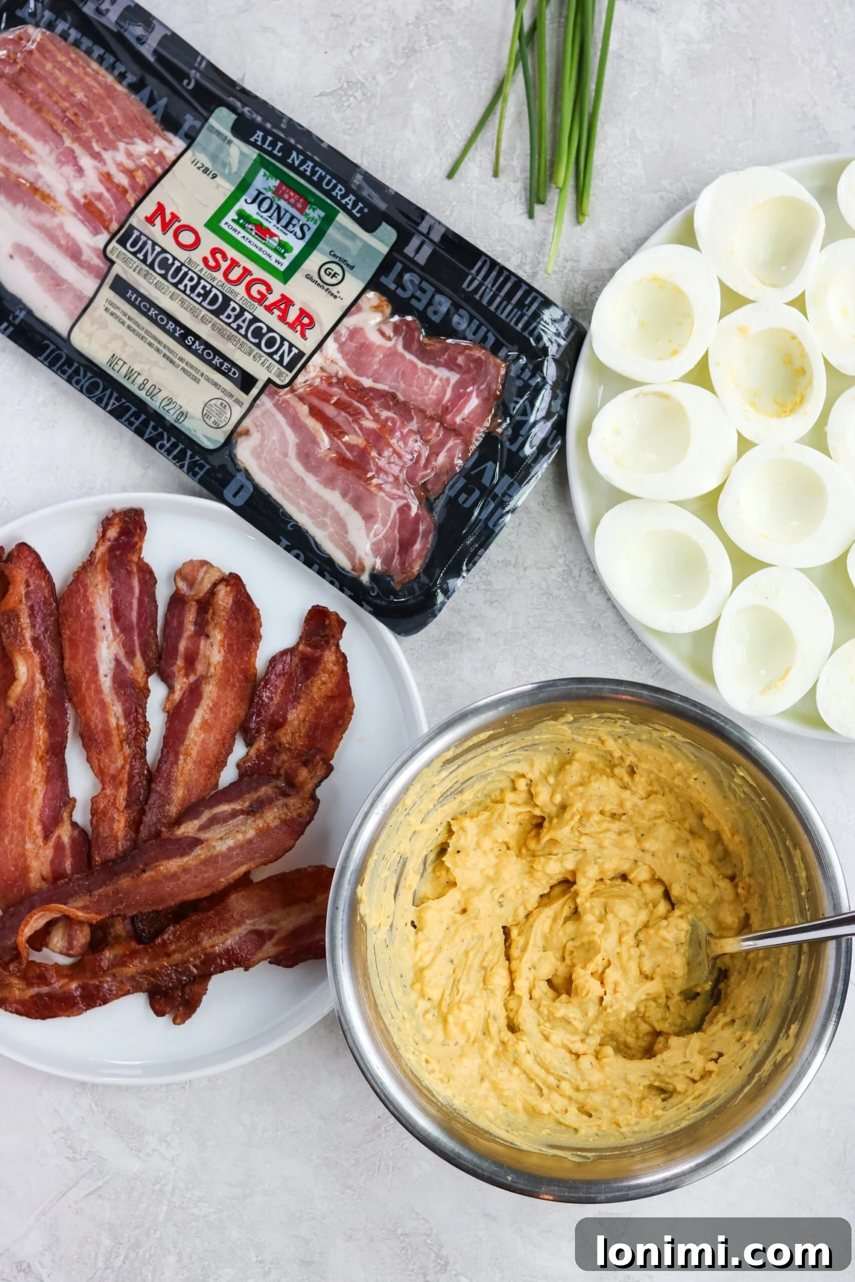 Elevated Whole30 Bacon Ranch Deviled Eggs 5 Mixing ingredients for the creamy deviled egg filling